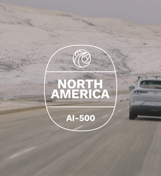 car driving down a road in snowy hilly setting