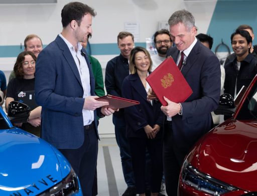 Peter Kyle, UK Business Secretary of State and Alex Kendall, CEO and co-founder of Wayve holding folders and signing a document