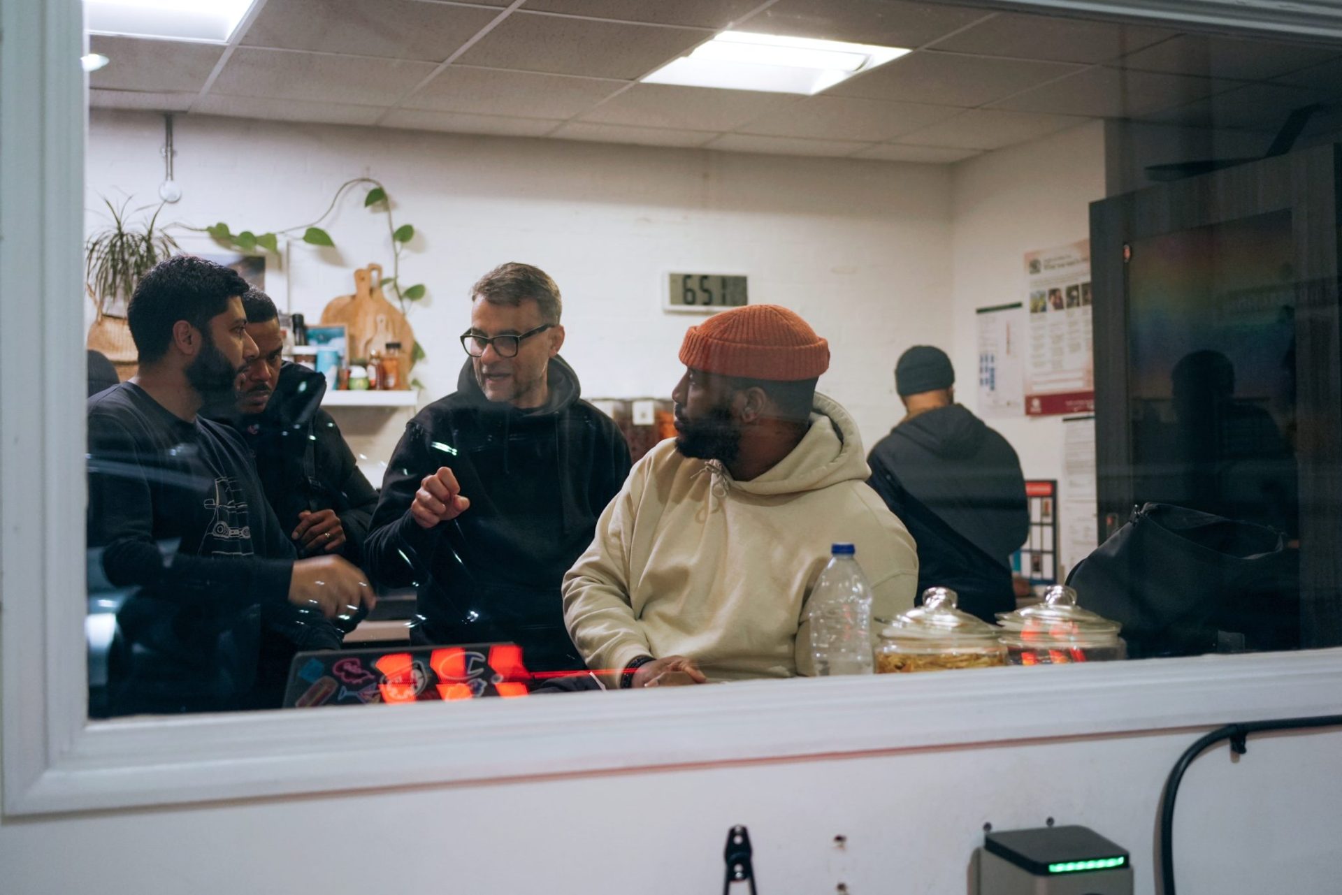 Group of Wayve employees talking in a small white room