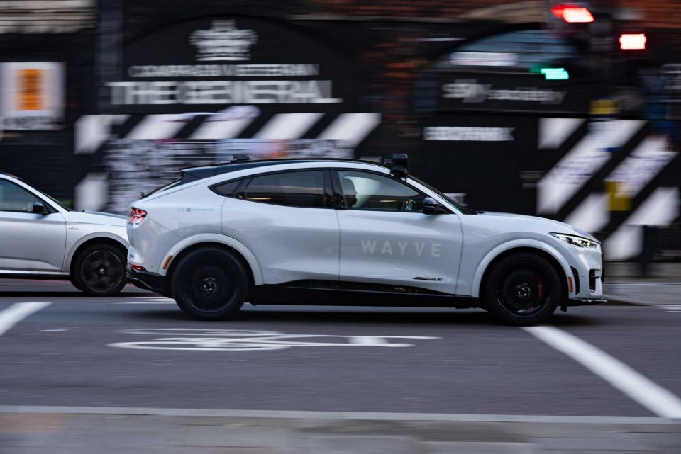 White wave car driving down the street in London