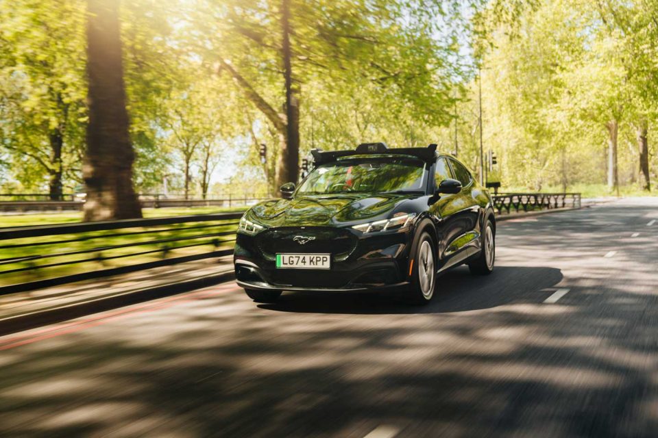 Wayve car navigating the streets around a park space with trees