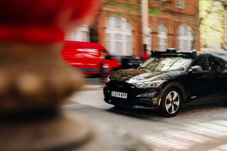 Wayve car navigating the streets in urban London dow a side street