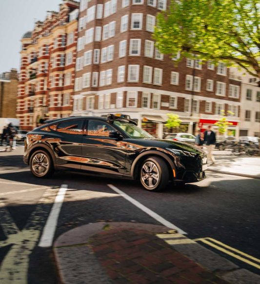 Wayve car navigating the streets in urban London at a cross section