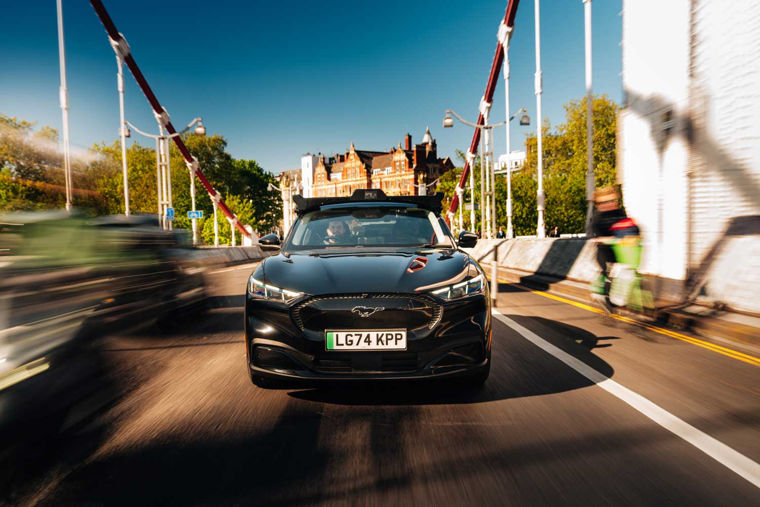 Wayve car navigating the streets in urban London travelling over a bridge