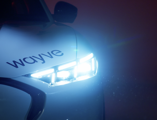 silver car with headlight on in a dark room