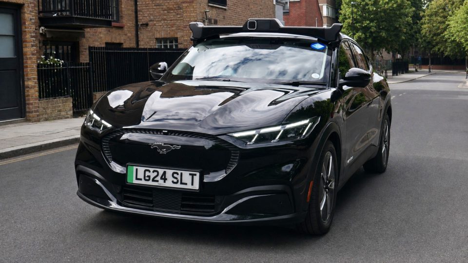 black car driving on a quiet street