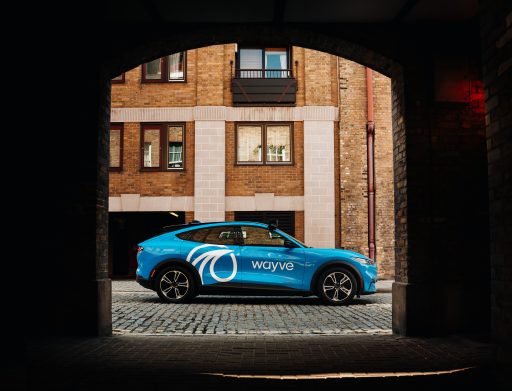 blue car parked between an arch on a sunny day